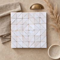 Cloud Triangle Zellige Mosaic Sheet styled on an interior design mood board with linen and brass