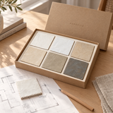 Handtile Trade Sample Box of neutral zellige samples on a designer's desk next to floor plans and a fabric swatch