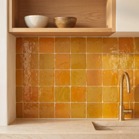 Saffron Orange Zellige Square 4x4 installed as a handmade Moroccan kitchen backsplash
