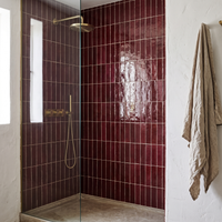 Burgundy Talia Zellige Mosaic Sheet installed as a handmade bathroom shower wall