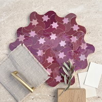 Star Swirl Zellige Mosaic Tile, Raspberry & Pink, styled on a designer mood board with linen, brass, and oak