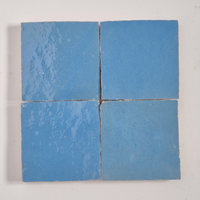 Close up of four Sky Blue Zellige Square 4x4 tiles showing glaze variation