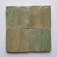 Close up of four Olive Green Zellige Square 4x4 tiles showing glaze variation