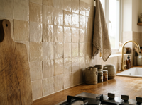 Linen Beige Zellige Square 4x4 installed as a handmade Moroccan kitchen backsplash with oak cabinetry and brass tap