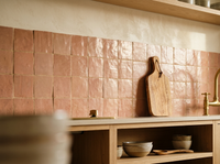 Terracotta Rose Zellige Square 4x4 installed as a handmade Moroccan kitchen backsplash with oak shelving and brass tap