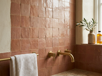 Terracotta Rose Zellige Square 4x4 on a handmade Moroccan bathroom wall with plaster walls and travertine floor